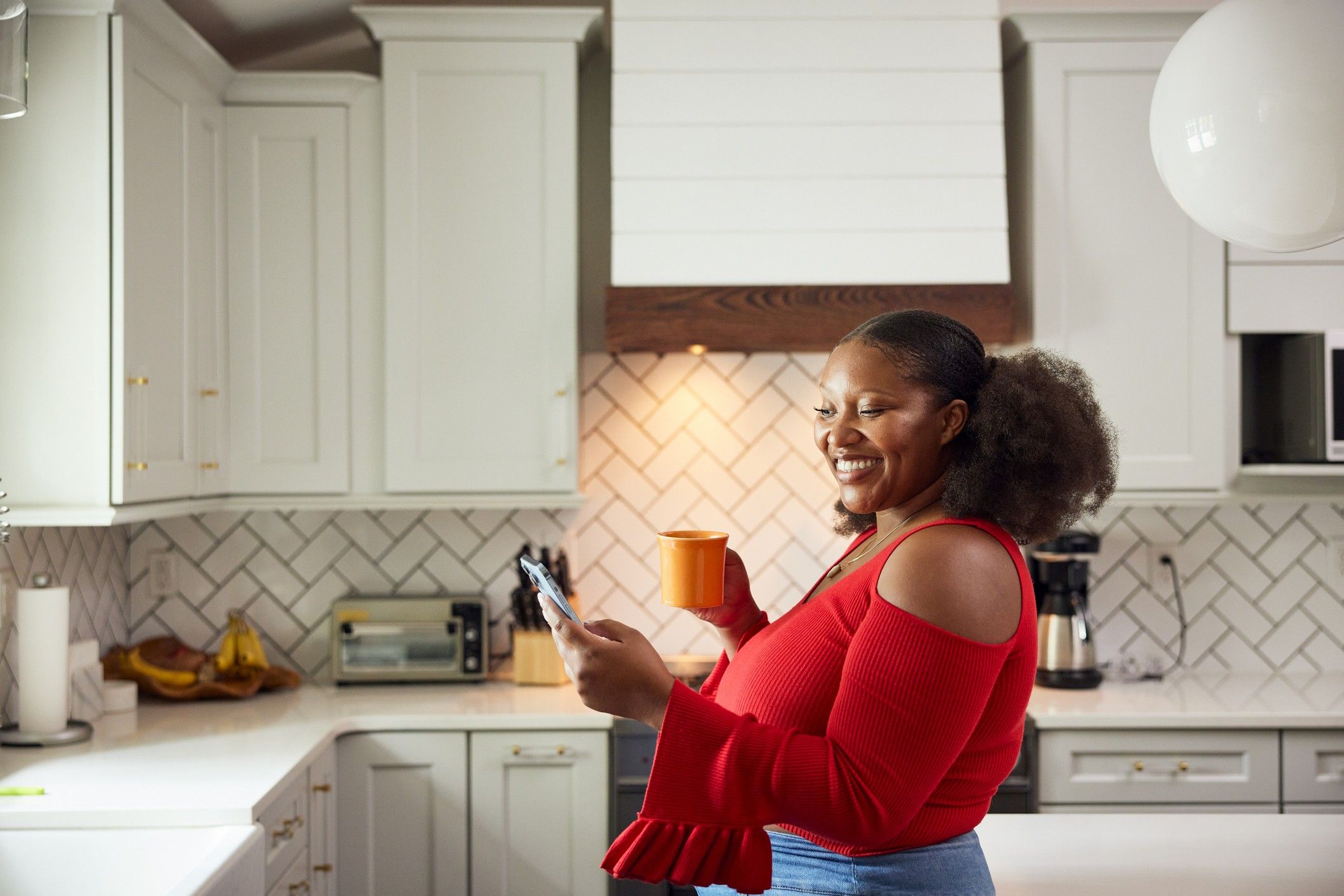 Woman-smiling-in-her-kitchen-buying-her-first-home